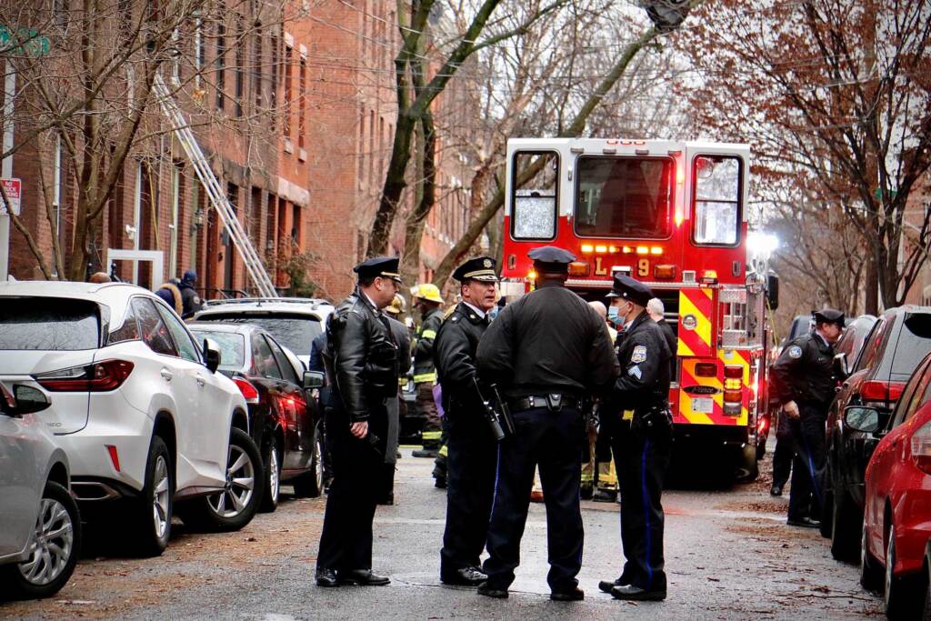 fairmount-rowhouse-fire-e-lee-01-010522 Police confer at the scene of a fire on North 23rd Street