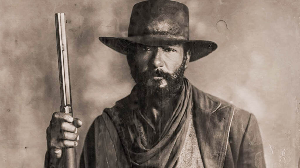 flicks-1883 Black and white image of Tim McGraw holding a gun to the air in the