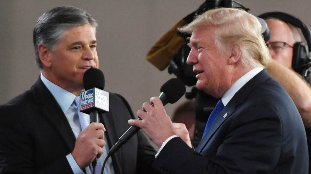 Fox News host Sean Hannity interviews then-President Donald Trump in 2018 in Las Vegas. Fox News Channel and radio talk show host Sean Hannity (left) interviews U.S. President Donald Trump before a campaign rally at the Las Vegas Convention Center on September 20, 2018 in Las Vegas, Nevada. (Photo by Ethan Miller/Getty Images)