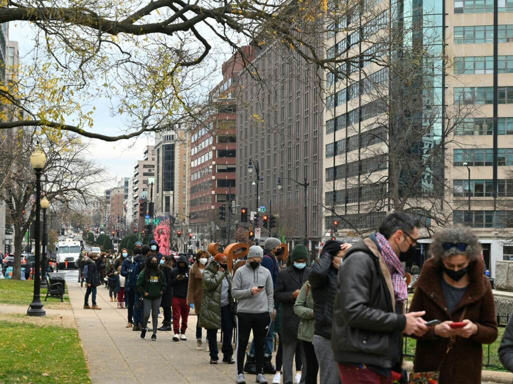 People line up to get tested for COVID-19 at a testing site in Washington, D.C., on Wednesday. More than 1 million Americans tested positive for COVID-19 on Monday, according to data from Johns Hopkins University. People line up to get tested for COVID-19 at a testing site in Washington, DC
