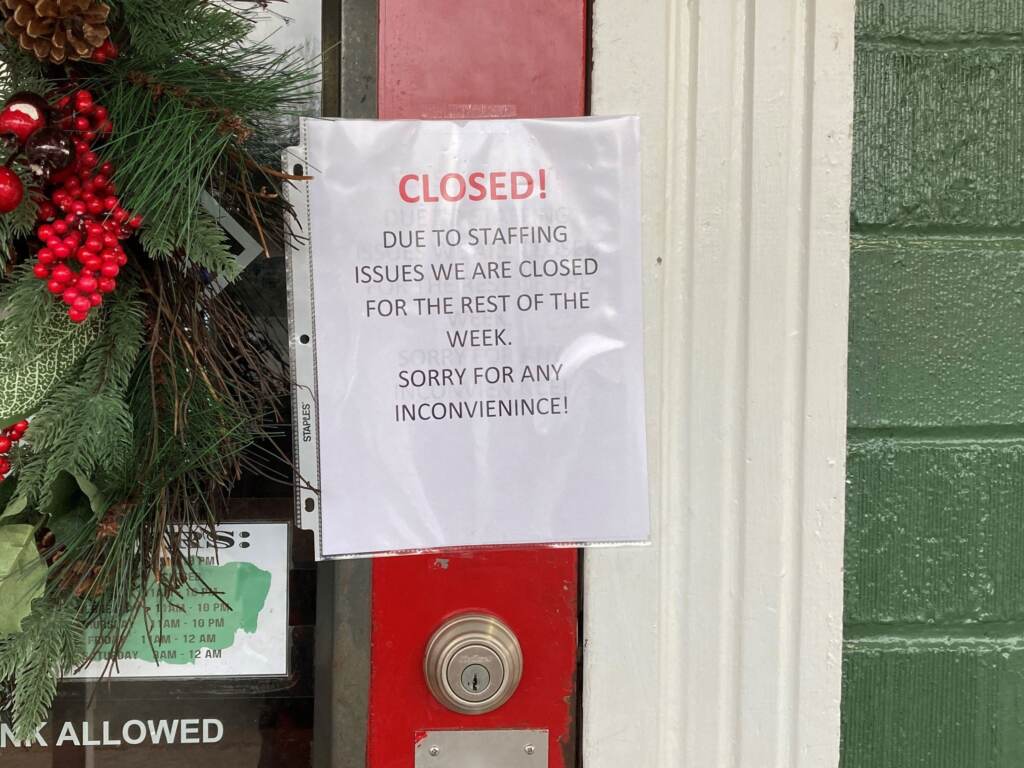 A closed sign is taped to the door of the Main Street Pub in Clifton, Virginia, on December 30, 2021. A closed sign is taped to the door of the Main Street Pub