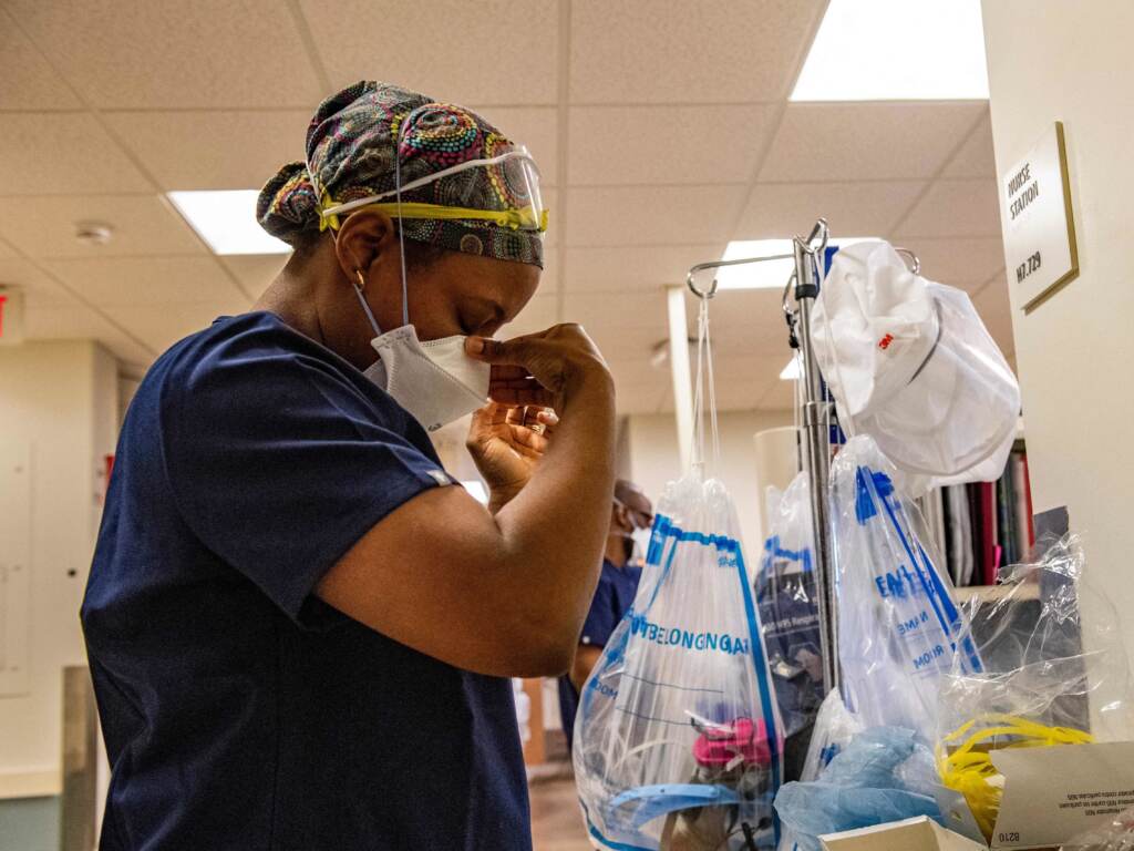 A medical worker puts on a mask before entering a negative pressure room with a Covid-19 patient in the ICU ward at UMass Memorial Medical Center in Worcester, Mass. on January 4, 2022. A medical worker puts on a mask before entering a negative pressure room with a Covid-19 patient in the ICU ward at UMass Memorial Medical Center in Worcester, Mass. on January 4, 2022. (Joseph Prezioso/AFP via Getty Images)