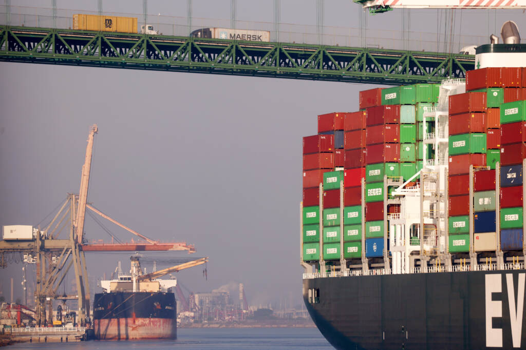 Trucks cross the Vincent Thomas Bridge above a container ship at the Port of Los Angeles on Nov. 30, 2021 in San Pedro, Calif. SAN PEDRO, CALIFORNIA - NOVEMBER 30: Trucks cross the Vincent Thomas Bridge above a container ship at the Port of Los Angeles on November 30, 2021 in San Pedro, California. U.S. Secretary of Labor Marty Walsh toured the Port of Los Angeles with local officials today to discuss initiatives aimed to ease disruptions in the supply chain. (Photo by Mario Tama/Getty Images)