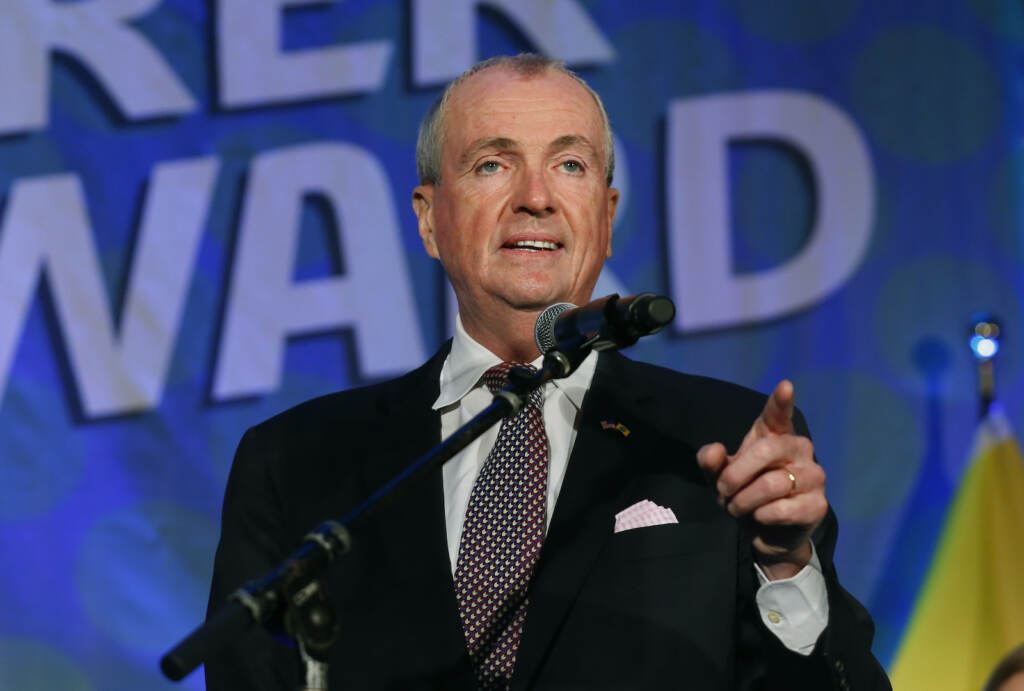 Virus Outbreak Governors New Jersey Gov. Phil Murphy gestures while standing behind a mic