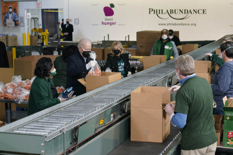President Joe Biden and first lady Jill Biden pack produce while volunteering at Philabundance