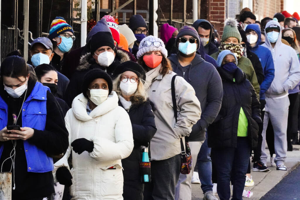 Virus Outbreak Test-Explainer City residents wait in a line extending around the block