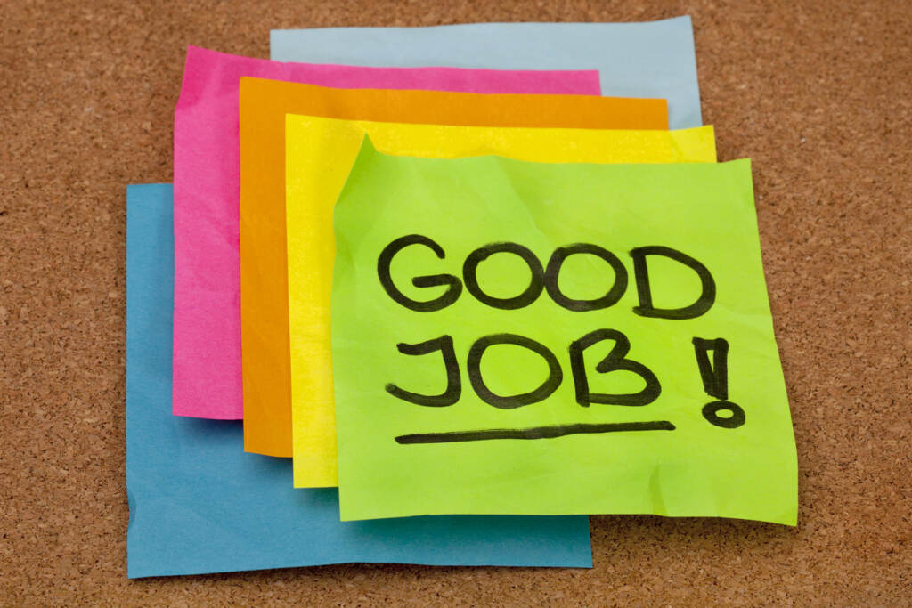 A stack of colorful sticky notes on cork bulletin board with 