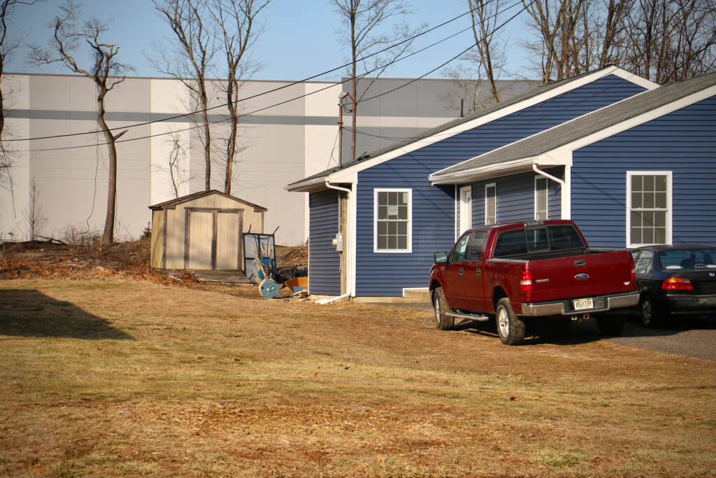 2022 02 05-e lee-lawnside nj-warehouse development-oak avenue redevelopment backyard An enormous warehouse looms behind modest homes on East Charleston Avenue