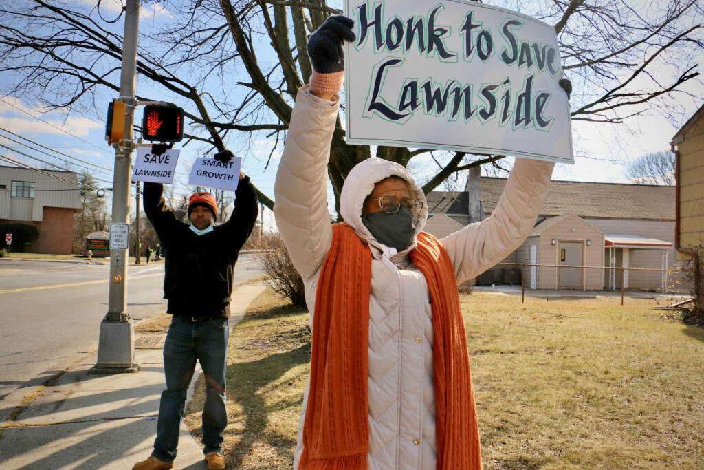 2022 02 05-e lee-stanley conaway jr linda shockley-lawnside nj-warehouse development Linda Shockley (right) and Stanley Conaway Jr. protest outside. Linda holds a sign that says,
