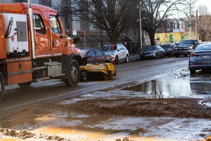 The cleanup of sediment and debris on streets surrounding a water main break
