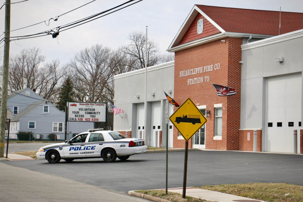 A Darby Townbship police car idles in front of the Briarcliffe Fire Company
