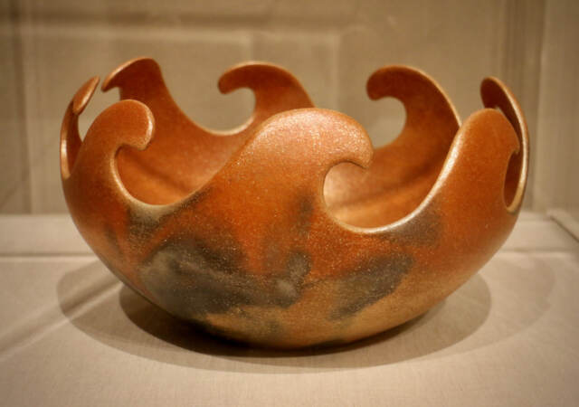 A modern vessel, created by Lonnie and Larry Vigil of the Nambé Pueblo, shows ''fire clouds,'' fire clouds, burn spots that are the result of traditional firing methods. Made from micaceous clay, this piece is called ''Earth, Fire, and Water,'' and is on loan to the Barnes from the Museum of Indian Arts and Culture/Laboratory of Anthropology in Santa Fe, N.M. (Emma Lee/WHYY)