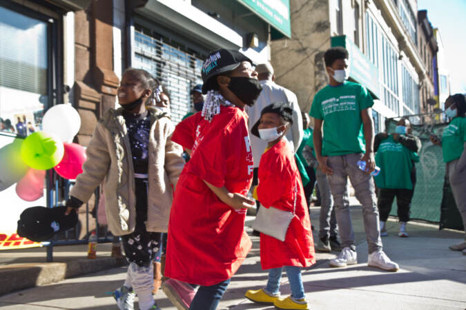 Zara Johnson, 6, smiles for the news cameras outside the opening of The Teen Safe Space on North Broad Street in Philadelphia, on February 21, 2022. (Kimberly Paynter/WHYY)