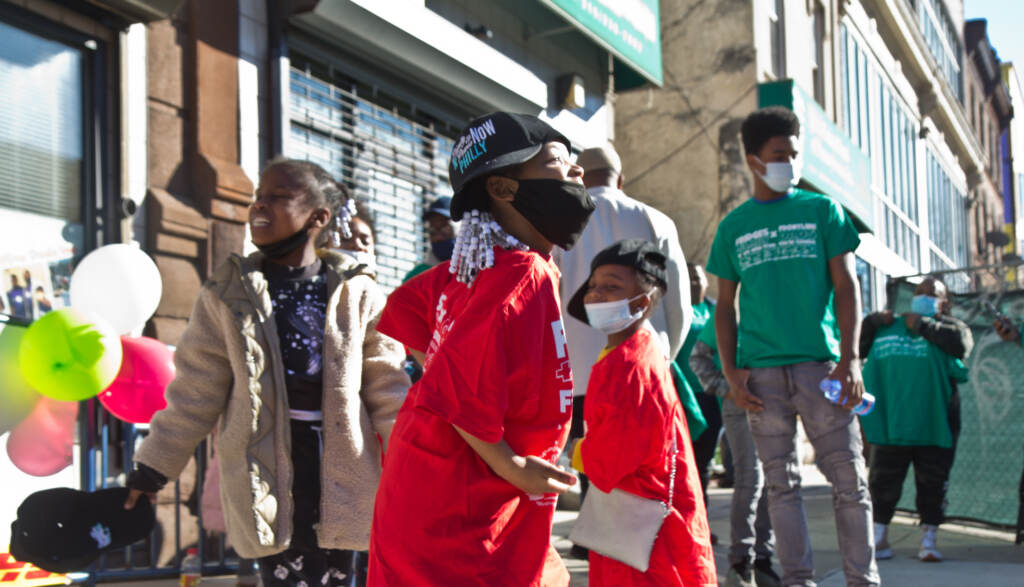 Zara Johnson, 6, smiles for the news cameras outside the opening of The Teen Safe Space on North Broad Street in Philadelphia, on February 21, 2022. (Kimberly Paynter/WHYY)