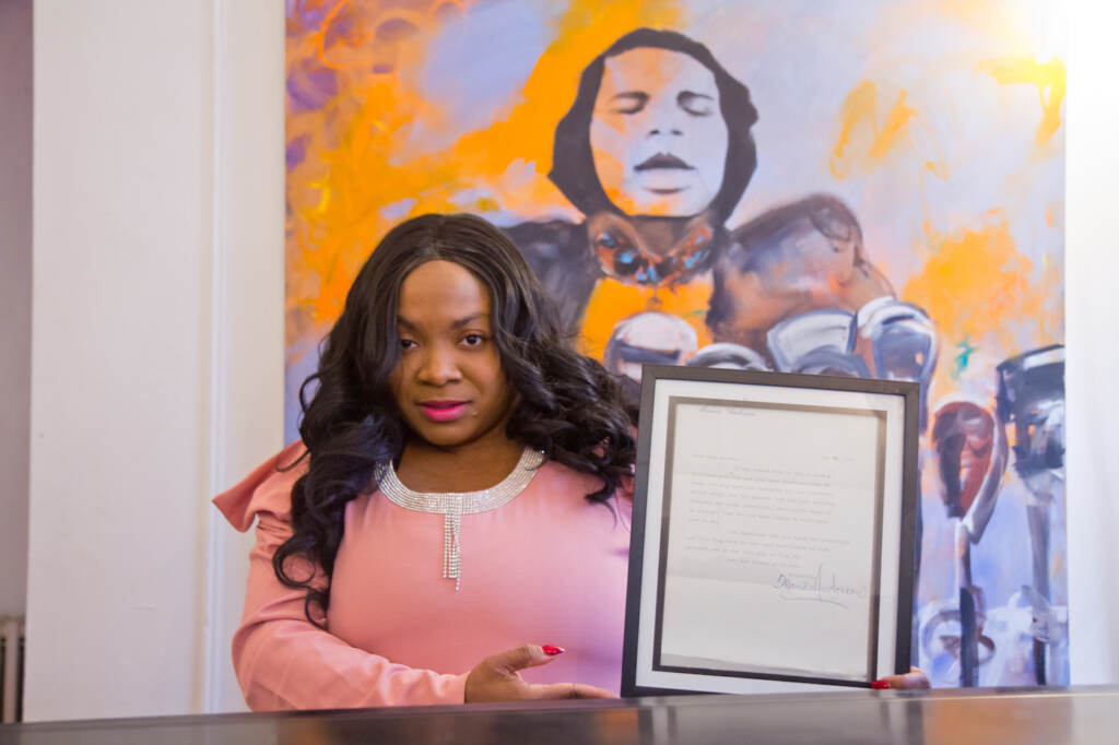 Jillian Patricia Pirtle, CEO of the Marian Anderson Museum & Historical Society, holds a letter written by Marian Anderson. Pirtle and actor Bryan Anthony Wilson will perform dramatic a reading of letters sent between Anderson and husband, Orpheus Fisher, at Philadelphia’s Penn Museum on February 13, 2022. (Kimberly Paynter/WHYY)