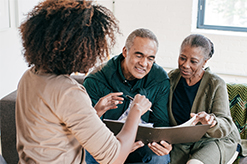 A middle aged couple talking to a financial advisor