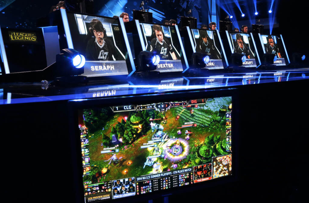 Esports Riot Games The names and faces of gamers are shown as they compete in a round of the League of Legends championship series video game competition