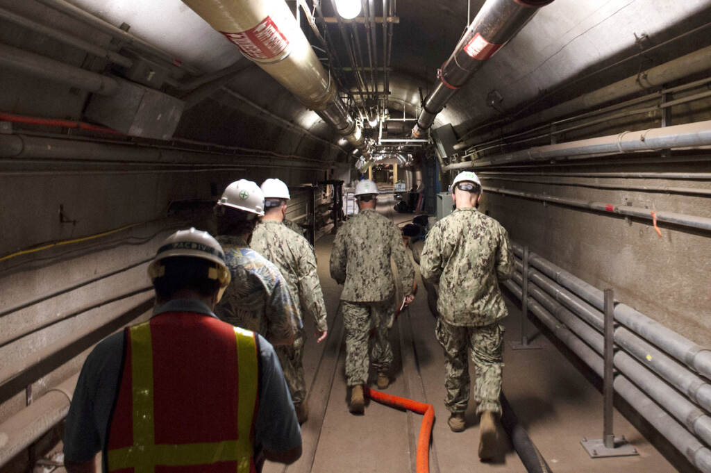 Hawaii Tainted Water In this Dec. 23, 2021, photo provided by the U.S. Navy, Rear Adm. John Korka, Commander, Naval Facilities Engineering Systems Command (NAVFAC), and Chief of Civil Engineers, leads Navy and civilian water quality recovery experts through the tunnels of the Red Hill Bulk Fuel Storage Facility, near Pearl Harbor, Hawaii. The Navy is scrambling to contain what one lawmaker has called a “crisis of astronomical proportions” after jet fuel leaked from an 80-year-old Hawaii tank farm, seeped into a drinking water well and polluted the water streaming out of faucets in Pearl Harbor military housing