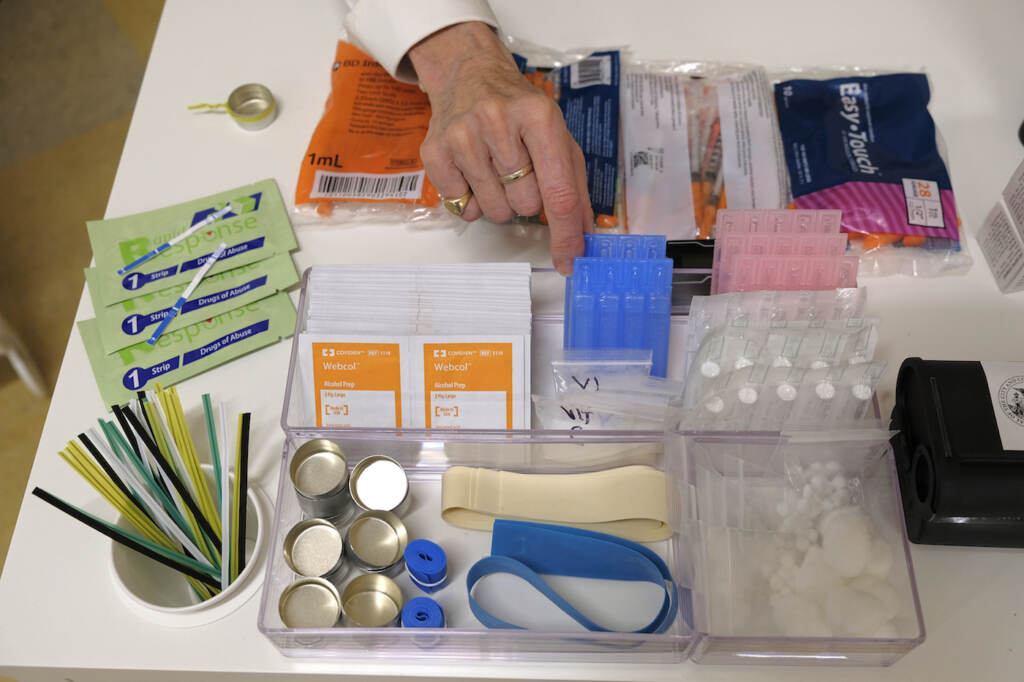 Safe Injection Sites File - Supplies are shown on a desk at Safer Inside, a realistic model of a safe injection site in San Francisco, Aug. 29, 2018. The Justice Department is signaling it might be open to allowing so-called safe injection sites, or safe havens for people to use heroin and other narcotics with protections against fatal overdoses. The department's stance comes a year after federal prosecutors won a major court ruling that found the sites would violate federal law. The Justice Department tells The Associated Press it is talking to regulators about “appropriate guardrails” for the sites. (AP Photo/Eric Risberg, File)