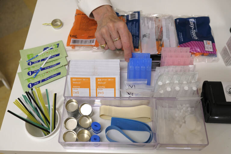 File - Supplies are shown on a desk at Safer Inside, a realistic model of a safe injection site in San Francisco,  Aug. 29, 2018. The Justice Department is signaling it might be open to allowing so-called safe injection sites, or safe havens for people to use heroin and other narcotics with protections against fatal overdoses. The department's stance comes a year after federal prosecutors won a major court ruling that found the sites would violate federal law. The Justice Department tells The Associated Press it is talking to regulators about “appropriate guardrails” for the sites. (AP Photo/Eric Risberg, File)