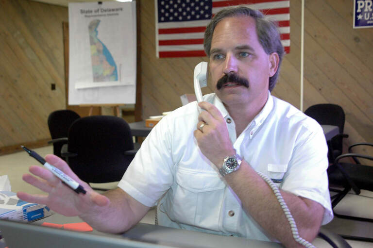 Then-Delaware Republican Senatorial candidate Mike Protack takes a call at his office in Wilmington, Del., on Aug. 14, 2006. The former Delaware political candidate who unsuccessfully sought the Republican nominations for governor and U.S. Senate has been sentenced to a year in prison after pleading guilty to federal charges of mailing threats to a lawyer who represented his wife in a divorce case. Protack was sentenced Tuesday, Feb. 8, 2022 after pleading guilty in August to two counts of mailing a threatening communication. (AP Photo/Pat Crowe II, file)