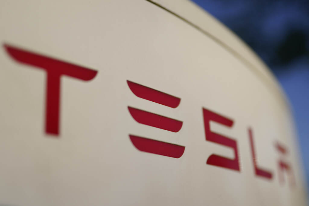 Tesla Recall File photo: The logo for the Tesla Supercharger station is seen in Buford, Ga, April 22, 2021,. Tesla is recalling nearly 579,000 vehicles in the U.S. because sounds played over an external speaker can obscure audible warnings for pedestrians. The recall is the fourth made public in the last two weeks as U.S. safety regulators increase scrutiny of the nation’s largest electric vehicle maker
