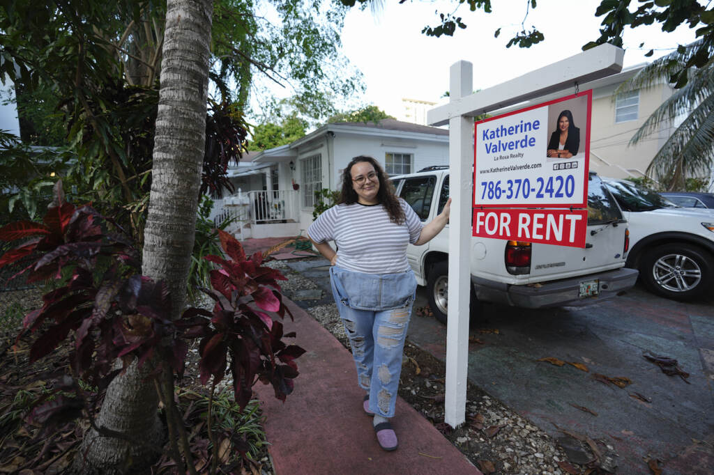 Soaring Rents Krystal Guerra, 32, poses for a picture outside her apartment, which she has to leave after her new landlord gave her less than a month's notice that her rent would go up by 26%, Saturday, Feb. 12, 2022, in the Coral Way neighborhood of Miami. Guerra, who works in marketing while also pursuing a degree part-time, had already been spending nearly 50% of her monthly income on rent prior to the increase. Unable to afford a comparable apartment in the area as rents throughout the city have risen dramatically, Guerra is putting many of her belongings into storage and moving in with her boyfriend and his daughter for the time being. (AP Photo/Rebecca Blackwell)