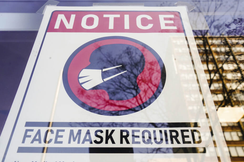 A sign requiring masks as a precaution against the spread of the coronavirus