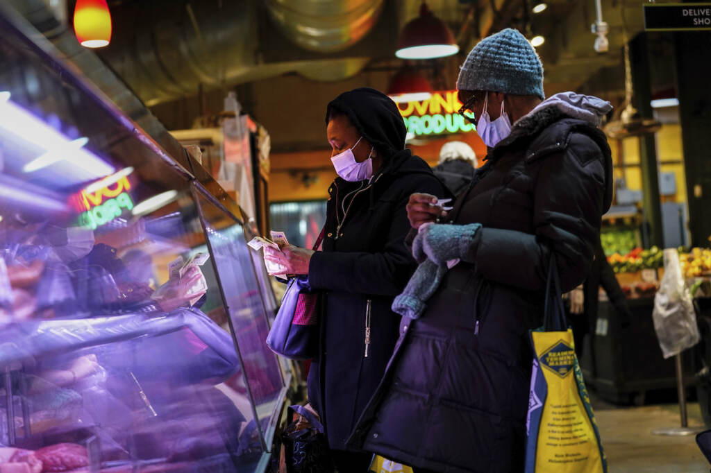 Virus Outbreak Pennsylvania Customers wear face masks while shopping at the Reading Terminal Market