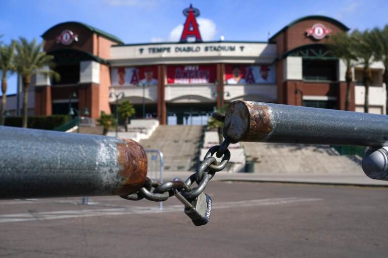 The main parking lot at the Los Angeles Angels Tempe Diablo Stadium remains closed as pitchers and catchers are not starting spring training workouts as scheduled as the Major League Baseball lockout enters its 77th day and will prevent pitchers and catchers from taking the field for the first time since October in Tempe, Ariz., Wednesday, Feb. 16, 2022. (AP Photo/Ross D. Franklin)