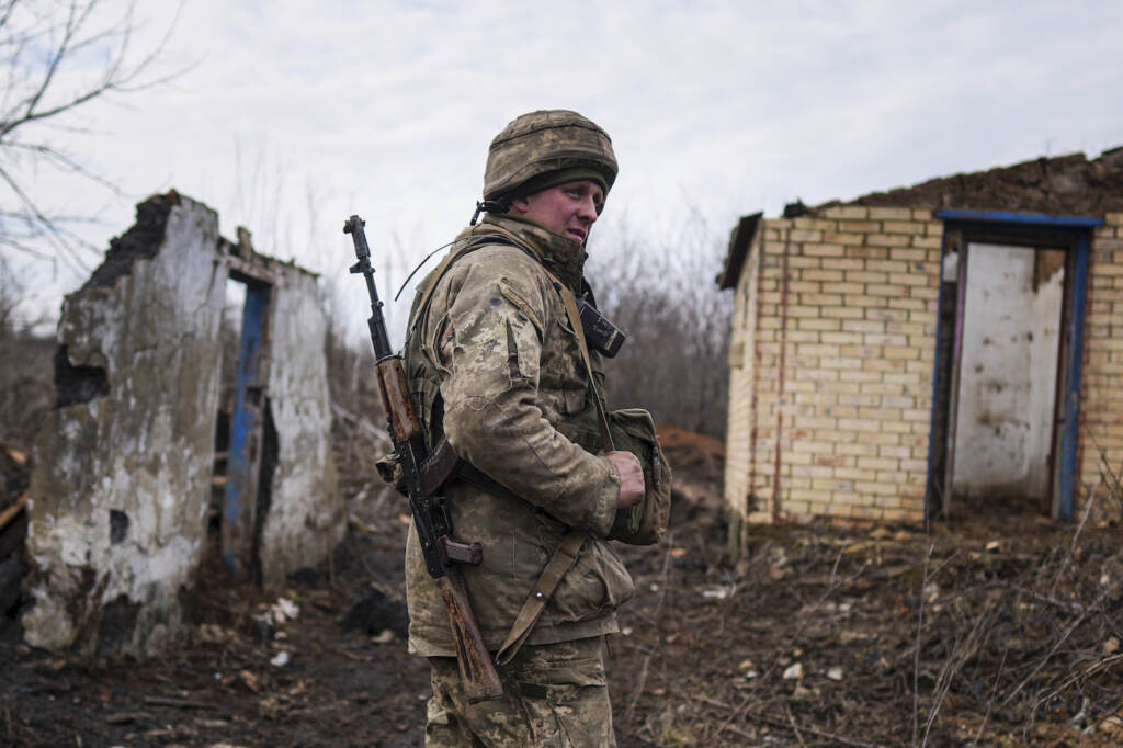 APTOPIX Ukraine Tensions A Ukrainian serviceman stands at his position at the line of separation between Ukraine-held territory and rebel-held territory near Svitlodarsk, eastern Ukraine, Wednesday, Feb. 23, 2022. U.S. President Joe Biden announced the U.S. was ordering heavy financial sanctions against Russia, declaring that Moscow had flagrantly violated international law in what he called the