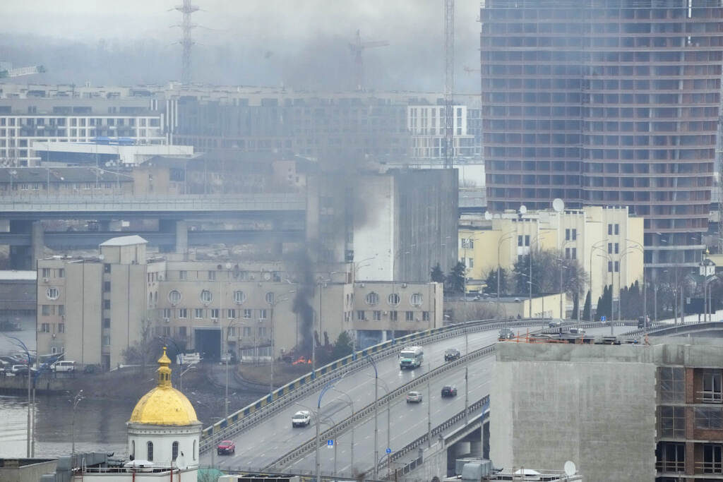 Ukraine Tensions Smoke and flame rise near a military building after an apparent Russian strike in Kyiv, Ukraine, Thursday, Feb. 24, 2022. Russian troops have launched their anticipated attack on Ukraine. Big explosions were heard before dawn in Kyiv, Kharkiv and Odesa as world leaders decried the start of an Russian invasion that could cause massive casualties and topple Ukraine's democratically elected government