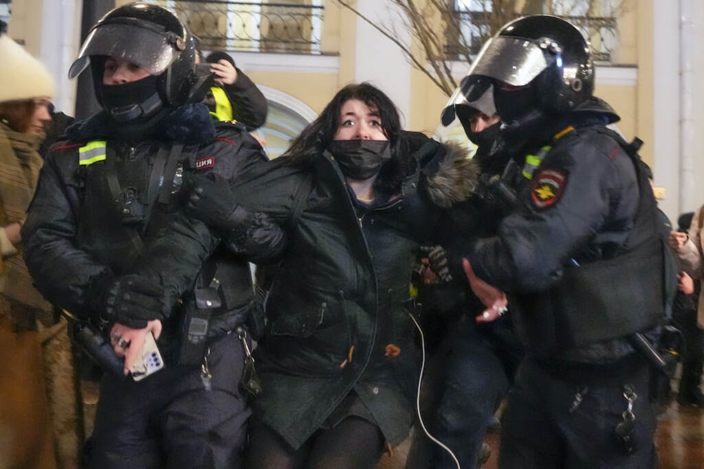 Russia Ukraine Invasion Police officers detain a woman in St. Petersburg, Russia, Friday, Feb. 25, 2022. Shocked Russians turned out by the thousands Thursday to decry their country's invasion of Ukraine as emotional calls for protests grew on social media. Some 1,745 people in 54 Russian cities were detained, at least 957 of them in Moscow.