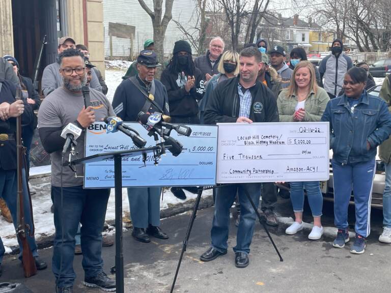 Representatives from the Amazon Black Employees Network based at hubs in Deptford and Florence present checks totaling $10,000 towards the restoration of Locust Hill Cemetery in Trenton. There will also be a Black history museum constructed on the site as well