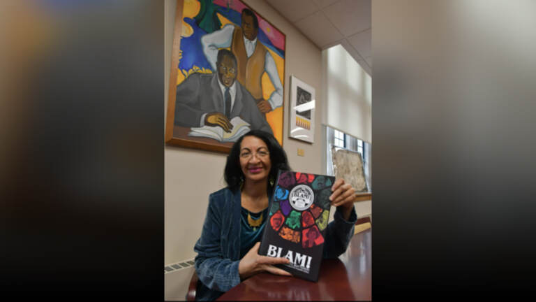 Curator of the Charles L. Blockson Afro-American Collection Diane Turner holds a copy of the graphic novel BLAM! (Abdul Sulayman / The Philadelphia Tribune)