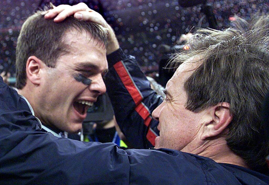 New England Patriots' quarterback Tom Brady celebrates with head coach Bill Belichick