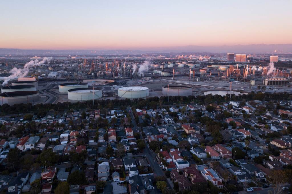 An aerial image shows storage tanks at the Chevron Products Company El Segundo Refinery adjacent to a neighborhood of homes at sunset in Manhattan Beach, Calif., on Jan. 24. An aerial image shows storage tanks at the Chevron Products Company El Segundo Refinery