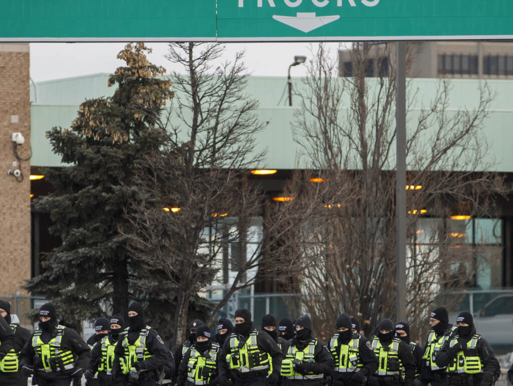 Police arrive to clear protestors and their vehicles from a blockade at the entrance to the  Ambassador Bridge, that was sealing off the flow of commercial traffic over the bridge into Canada from Detroit, on February 12, 2022 in Windsor, Canada. (Photo by Cole Burston/Getty Images)