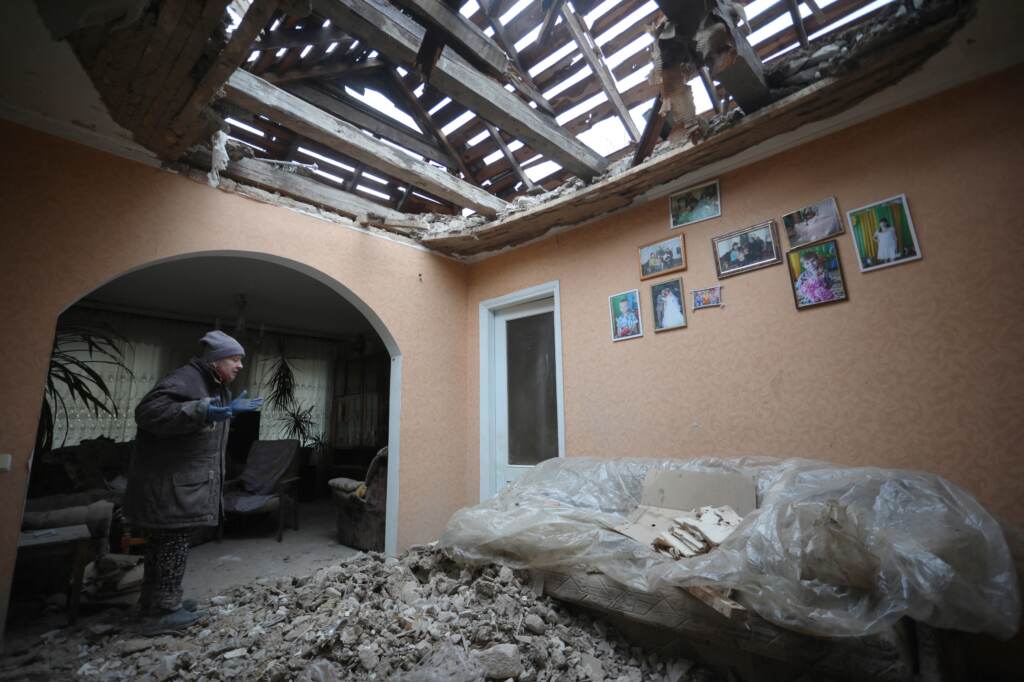 A local resident of the Ukrainian-controlled village of Stanytsia Luhanska, Luhansk region, gestures as she cleans up debris from her home after the shelling by Russia-backed separatists on February 18, 2022. A local resident of the Ukrainian-controlled village of Stanytsia Luhanska, Luhansk region, gestures as she cleans up debris from her home after the shelling by Russia-backed separatists on February 18, 2022. (AlekseyFilippov/AFP via Getty Images)