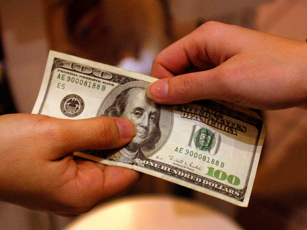 A shopper pays cash for sales merchandise on Dec. 26, 2000 in Austin, Texas. The Federal Reserve is considering whether to adopt a digital version of the dollar, in what would amount to a fundamental rethink of our national currency. A shopper pays cash for sales merchandise on Dec. 26, 2000 in Austin, Texas. The Federal Reserve is considering whether to adopt a digital version of the dollar, in what would amount to a fundamental rethink of our national currency. (Joe Raedle/Getty Images)