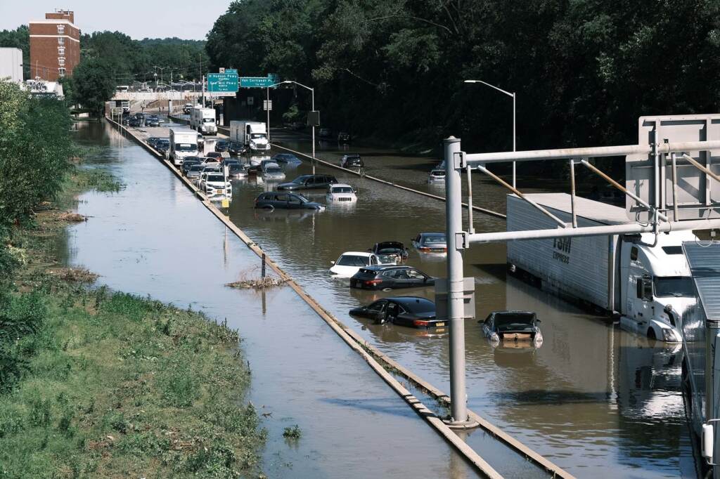 Heavy rain from the remnants of Hurricane Ida flooded roads and expressways in New York in 2021. In a hotter climate, rainstorms are becoming more intense. Cars sit abandoned on the flooded Major Deegan Expressway