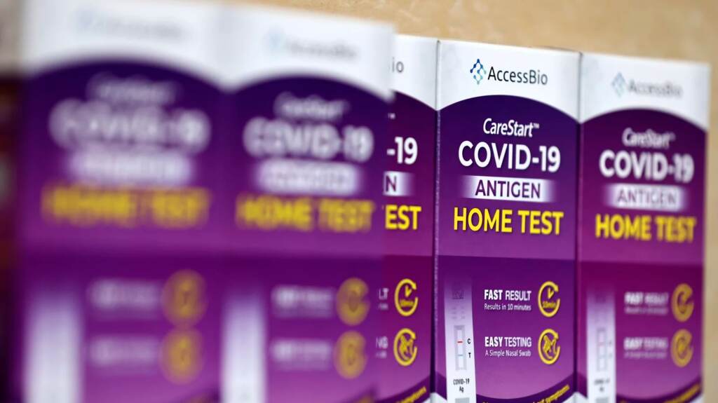 COVID-19 at-home rapid test kits are seen in Los Angeles on Jan. 7. COVID-19 rapid at-home test kits rest on a table at a free distribution event for those who received vaccination shots or booster shots, at Union Station, on January 7, 2022 in Los Angeles, California. (Photo by Mario Tama/Getty Images)