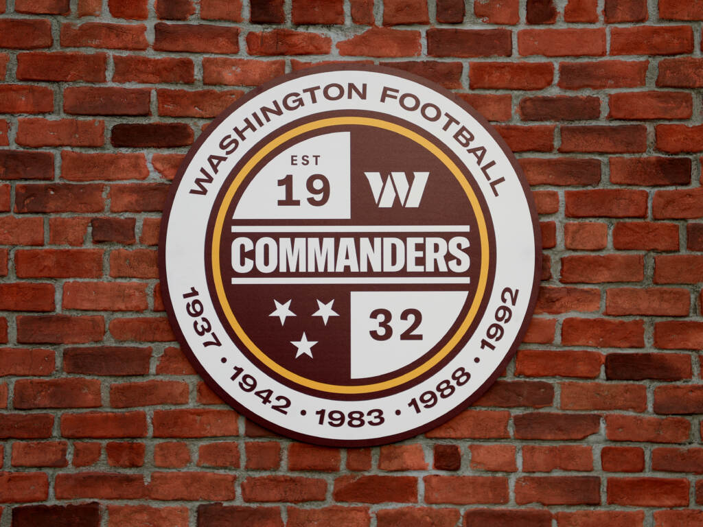 A detailed view of a Washington Commanders logo during the announcement of the Washington Football Team’s name change — an announcement welcomed by Native American activists who felt the team’s former “Redskins” nickname was denigrating to their identity and culture. A detailed view of a Washington Commanders logo during the announcement of the Washington Football Team's name change — an announcement welcomed by Native American activists who felt the team's former