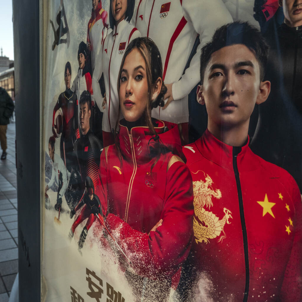 An ad for Chinese sportswear company shows American-born freestyle skiing gold medalist Eileen Gu, or Gu Ailing and other athletes competing for China at the Beijing 2022 Winter Olympics on a street on last week in Beijing. (Kevin Frayer/Getty Images)