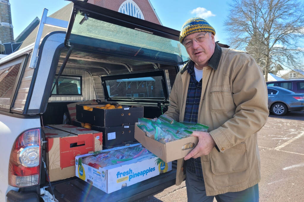 good-souls-123_1 Lou Farrell loading the trunk of a car with packages of peanut butter and jelly sandwiches and other snacks