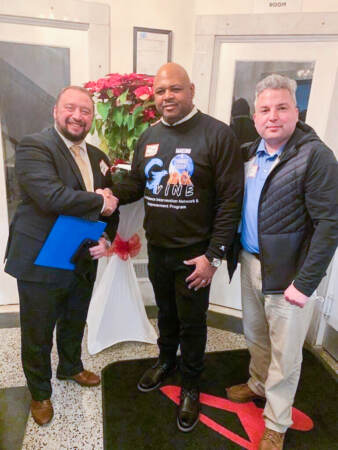 Cory Long with two other men at a community event