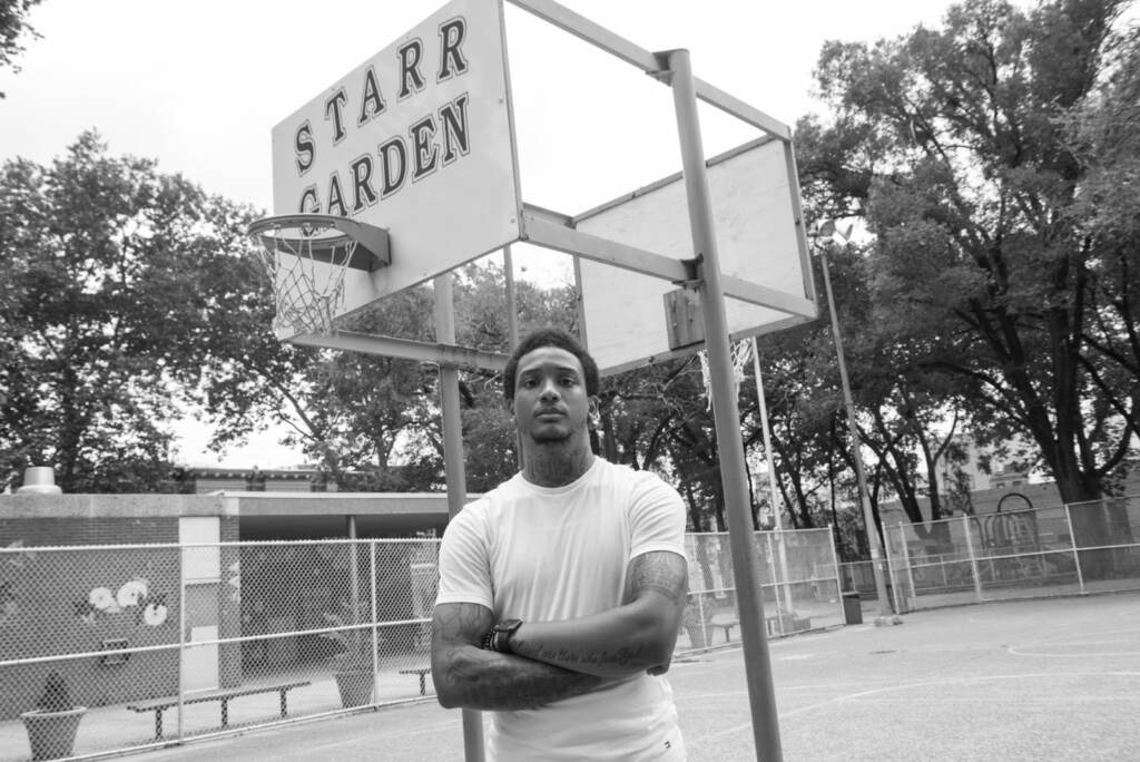 Mike White is seen standing on a basketball court in Philly