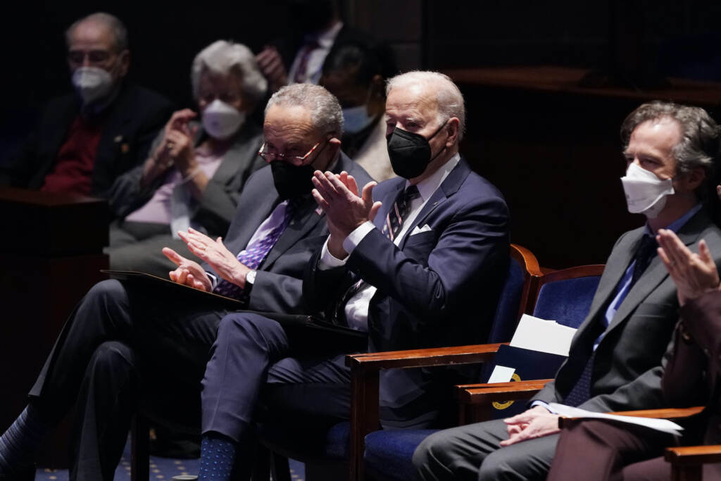 Joe Biden,Chuck Schumer President Joe Biden and others clap while seated at the National Prayer Breakfast
