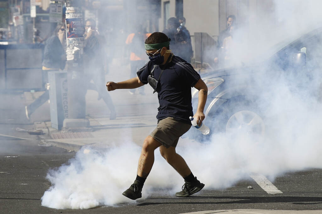 America Protests Philadelphia A protester kicks a tear gas canister fired by police as protests continue Sunday, May 31, 2020, in Philadelphia over the death of George Floyd. Floyd died May 25 after he was pinned at the neck by a Minneapolis police officer. (AP Photo/Matt Rourke)