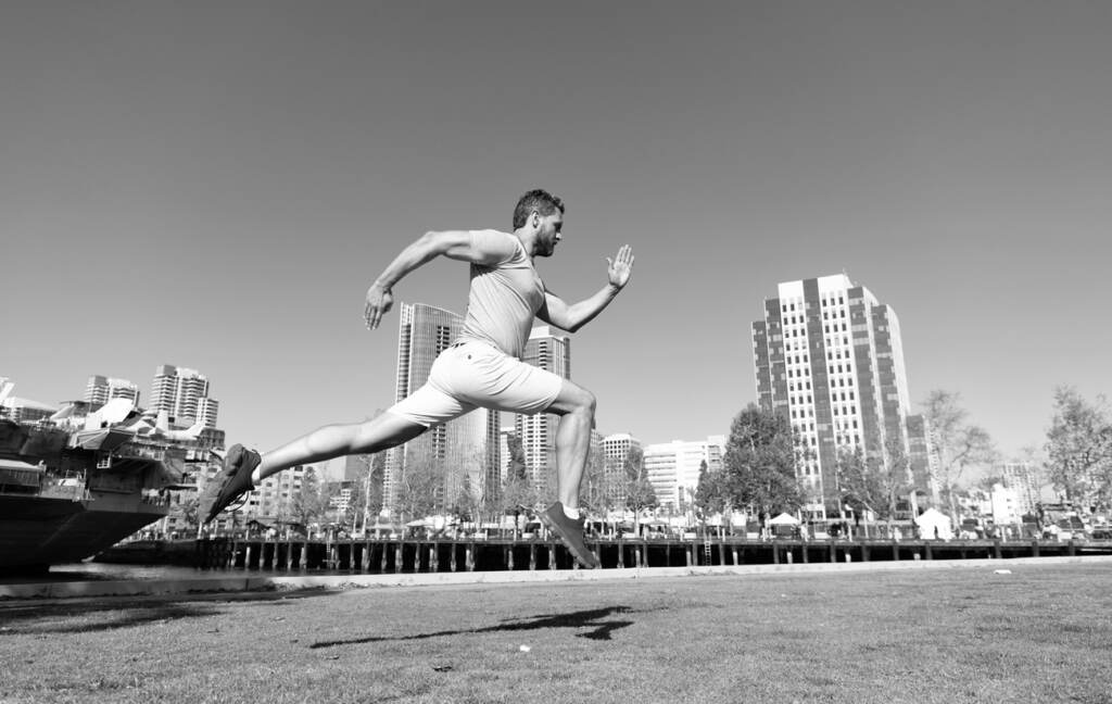 the-pulse-bigstock-Run-Fast-Energetic-Guy-Run-Ou-439158065 A black and white image of a man leaping and running with a city skyline in the background